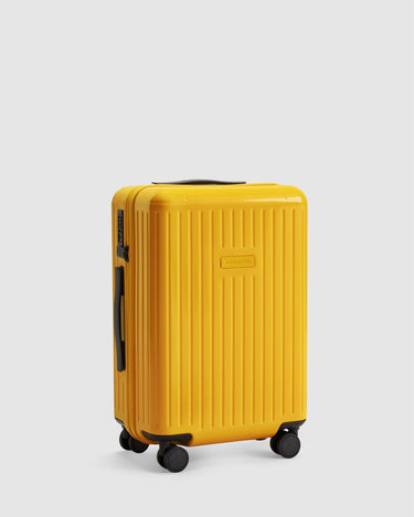 gold yellow carry on suitcase with 4 wheels - side view